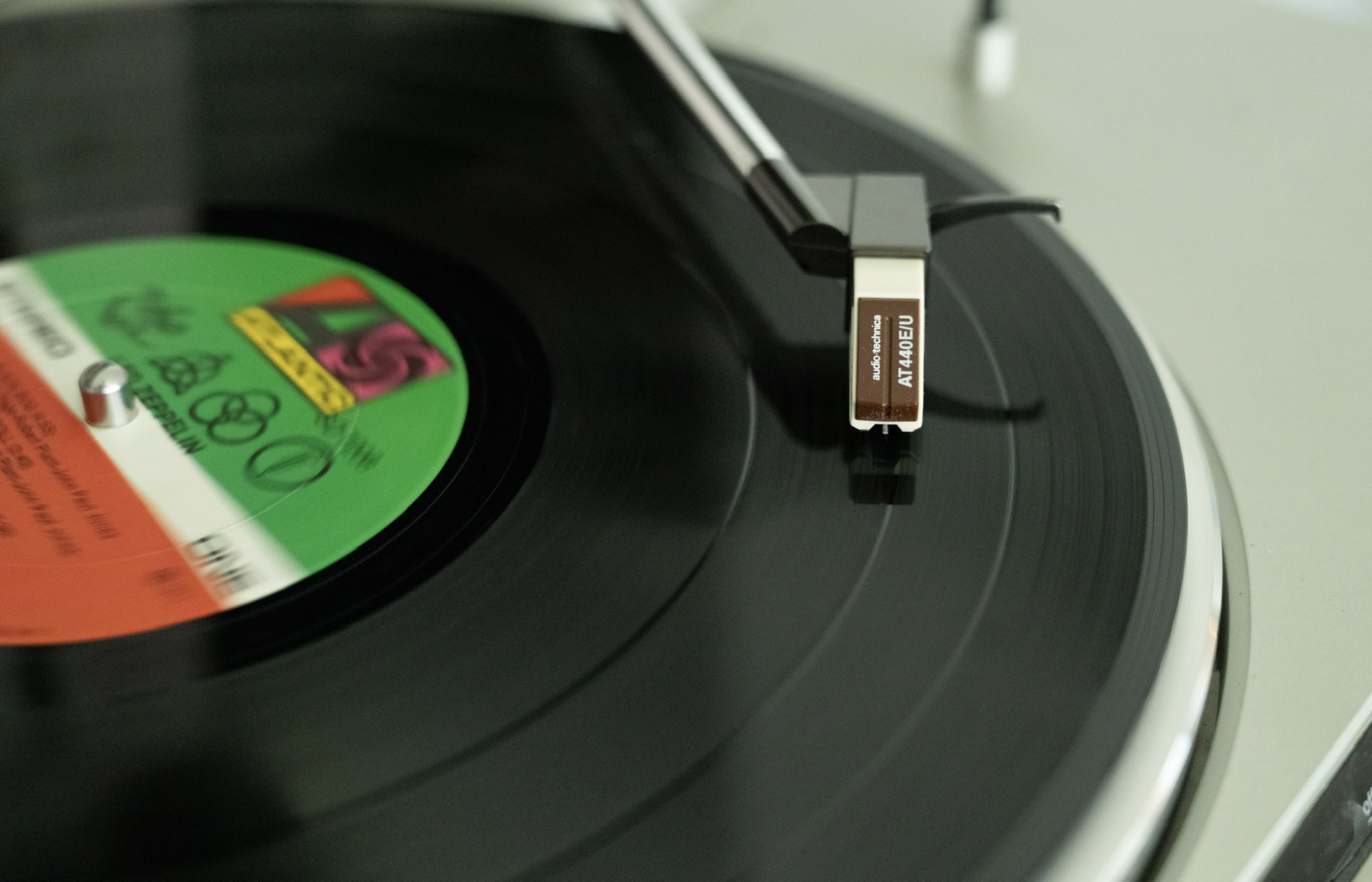 A Led Zeppelin record on a turntable with the needle down and the record playing